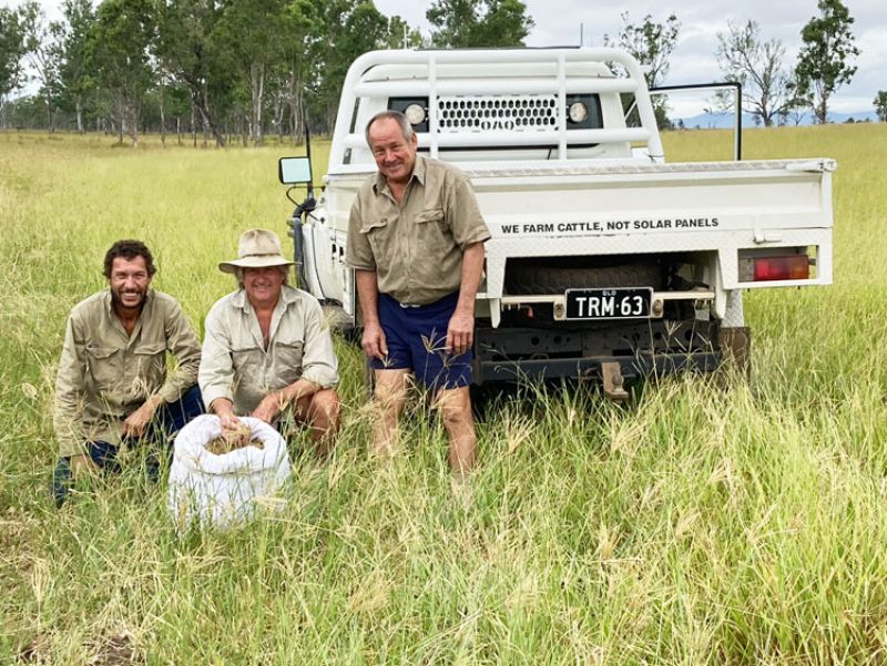 3 male graziers in a paddock with a white utility vehicle